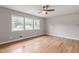 Bright bedroom with hardwood floors, a ceiling fan, and natural light from windows at 3325 Old Buffaloe Rd, Raleigh, NC 27604