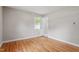 Light and airy bedroom featuring hardwood floors at 3325 Old Buffaloe Rd, Raleigh, NC 27604