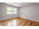 Well lit bedroom features hardwood flooring and natural light at 3325 Old Buffaloe Rd, Raleigh, NC 27604