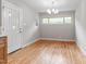 Light-filled dining room featuring hardwood floors and modern lighting at 3325 Old Buffaloe Rd, Raleigh, NC 27604