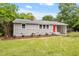 Charming single story home featuring a well-manicured lawn and inviting red front door at 3325 Old Buffaloe Rd, Raleigh, NC 27604