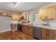 Modern kitchen features hardwood floors, bright wooden cabinets, and stainless-steel appliances at 3325 Old Buffaloe Rd, Raleigh, NC 27604