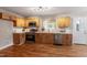 Updated kitchen featuring hardwood floors, wooden cabinets, and modern stainless-steel appliances at 3325 Old Buffaloe Rd, Raleigh, NC 27604
