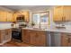 Modern kitchen with wooden cabinets, stainless-steel appliances, and bright countertops at 3325 Old Buffaloe Rd, Raleigh, NC 27604