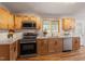 Newly updated kitchen boasts wooden cabinets, stainless steel appliances and bright countertops at 3325 Old Buffaloe Rd, Raleigh, NC 27604