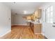 Open-concept floorplan with hardwood flooring and updated kitchen at 3325 Old Buffaloe Rd, Raleigh, NC 27604