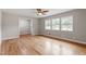 Open living room features hardwood floors, a ceiling fan, and bright natural light at 3325 Old Buffaloe Rd, Raleigh, NC 27604