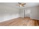 Living room featuring hardwood floors, a ceiling fan, and access to other rooms at 3325 Old Buffaloe Rd, Raleigh, NC 27604