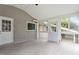 A sunroom featuring neutral walls, light grey flooring, and multiple access doors to the yard and house at 3325 Old Buffaloe Rd, Raleigh, NC 27604