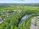 An aerial view of houses nestled among lush trees and a winding creek in a beautiful neighborhood at 4 Pickard Pl, Durham, NC 27703