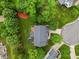Aerial view of the home with lush greenery, mature trees, a deck, and a jacuzzi nestled in the backyard at 4 Pickard Pl, Durham, NC 27703