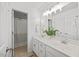 All-white bathroom featuring a double vanity, large mirror, and updated fixtures at 4 Pickard Pl, Durham, NC 27703