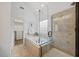 Elegant bathroom featuring soaking tub with a glass-enclosed shower and walk-in closet at 4 Pickard Pl, Durham, NC 27703