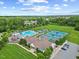 Aerial view of community pool with playground, tennis courts, picnic area, and clubhouse at 4 Pickard Pl, Durham, NC 27703