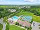 Aerial view of the community pool, playground, tennis courts, and clubhouse with ample parking at 4 Pickard Pl, Durham, NC 27703