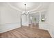 Dining room showcasing hardwood floors, white crown molding and a columned archway with a view at 4 Pickard Pl, Durham, NC 27703