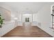 Bright entryway featuring hardwood floors, crown molding, and columned archway into a dining room with window at 4 Pickard Pl, Durham, NC 27703