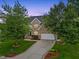 Beautiful brick home with a well-manicured lawn and a long driveway leading to an attached two-car garage at 4 Pickard Pl, Durham, NC 27703