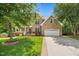 Charming brick home featuring a two-car garage, well-kept lawn, and inviting covered porch at 4 Pickard Pl, Durham, NC 27703