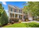 Beautiful brick home with manicured lawn and covered front porch with white columns at 4 Pickard Pl, Durham, NC 27703