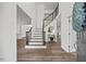 Elegant foyer featuring a staircase with iron railings, hardwood floors, and an open layout leading to other rooms at 4 Pickard Pl, Durham, NC 27703