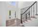 Bright foyer showcasing a staircase with detailed railings, large windows, and hardwood flooring, creating an inviting space at 4 Pickard Pl, Durham, NC 27703