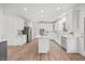Bright kitchen featuring white cabinets, a center island with a cooktop, stainless steel appliances, and modern finishes at 4 Pickard Pl, Durham, NC 27703