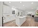 Spacious open kitchen with white cabinets, a large island, modern appliances, and hardwood floors throughout the space at 4 Pickard Pl, Durham, NC 27703