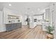 Bright and airy kitchen features white cabinetry, stainless steel appliances and a large center island at 4 Pickard Pl, Durham, NC 27703