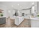 Open concept kitchen with white cabinetry, stainless steel appliances, an island cooktop, and modern countertops at 4 Pickard Pl, Durham, NC 27703