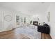 Bright living room features a fireplace, ceiling fan, large windows, and hardwood floors at 4 Pickard Pl, Durham, NC 27703