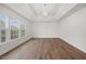Bright living room featuring hardwood floors, large windows, and a modern chandelier at 4 Pickard Pl, Durham, NC 27703