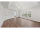 Spacious main bedroom with tray ceiling, hardwood floors, and ensuite bathroom at 4 Pickard Pl, Durham, NC 27703