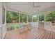 Inviting screened porch with ceiling fan, table, and chairs overlooking the private backyard at 4 Pickard Pl, Durham, NC 27703
