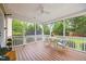 Inviting screened porch with ceiling fan, table, and chairs overlooking the well manicured lawn at 4 Pickard Pl, Durham, NC 27703