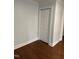 Cozy bedroom featuring hardwood floors, neutral walls, white trim and a closet at 401 Commonwealth St, Durham, NC 27703