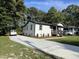 Charming renovated home with a concrete driveway, landscaped yard, and a welcoming front porch at 401 Commonwealth St, Durham, NC 27703