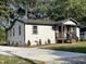 Charming renovated home with a concrete driveway, landscaped yard, and a welcoming front porch at 401 Commonwealth St, Durham, NC 27703