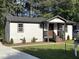Charming renovated home with a concrete driveway, landscaped yard, and a welcoming front porch at 401 Commonwealth St, Durham, NC 27703