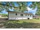 Back of the home features a freshly painted brick exterior, neat landscaping, and a view of the backyard at 460 Bunn Elementary School Rd, Bunn, NC 27508
