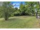 Picturesque backyard with lush greenery, mature trees, and a storage shed, perfect for outdoor activities at 460 Bunn Elementary School Rd, Bunn, NC 27508