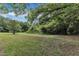 Expansive backyard with mature trees, offering a private and serene outdoor space at 460 Bunn Elementary School Rd, Bunn, NC 27508