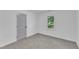 Bedroom with neutral carpet, light gray door, and bright window overlooking the property at 460 Bunn Elementary School Rd, Bunn, NC 27508