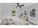 Bright bedroom with ceiling fan, modern art, and view to outside at 460 Bunn Elementary School Rd, Bunn, NC 27508