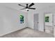 This bedroom is freshly painted and features soft carpet, a ceiling fan, and a gray door at 460 Bunn Elementary School Rd, Bunn, NC 27508