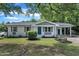 Charming single-story home featuring a white brick exterior, teal door, and a well-maintained front yard at 460 Bunn Elementary School Rd, Bunn, NC 27508