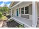 Inviting front porch featuring a vibrant turquoise door, neutral accents and classic architectural details at 460 Bunn Elementary School Rd, Bunn, NC 27508