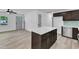 Open floor plan showcases a kitchen island with dark cabinetry and quartz countertops at 460 Bunn Elementary School Rd, Bunn, NC 27508