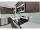 Kitchen with stainless appliances, sleek backsplash, and ample counterspace at 460 Bunn Elementary School Rd, Bunn, NC 27508