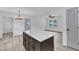 Kitchen island with quartz countertop and dark wood cabinets is the room's focal point at 460 Bunn Elementary School Rd, Bunn, NC 27508